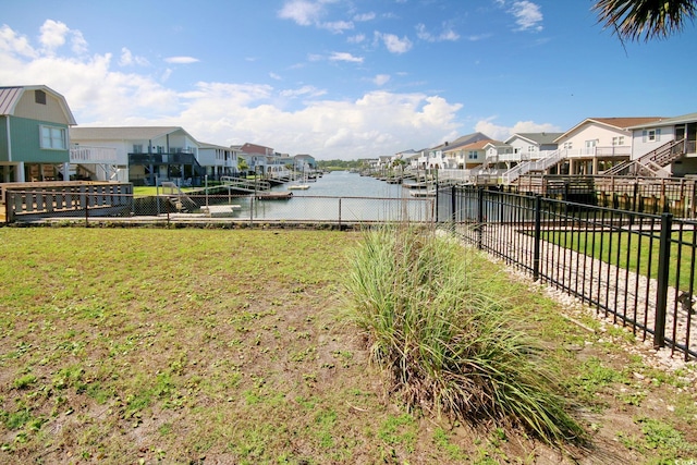 view of yard with a boat dock and a water view