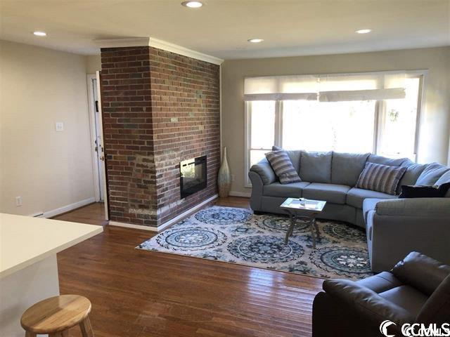 living room featuring a fireplace and dark hardwood / wood-style flooring