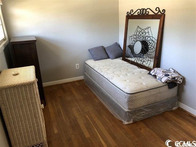 bedroom featuring dark hardwood / wood-style flooring