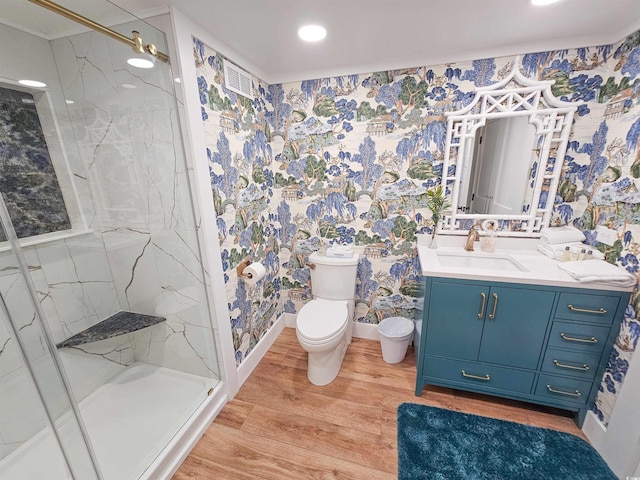 full bathroom featuring wood finished floors, toilet, a marble finish shower, and wallpapered walls