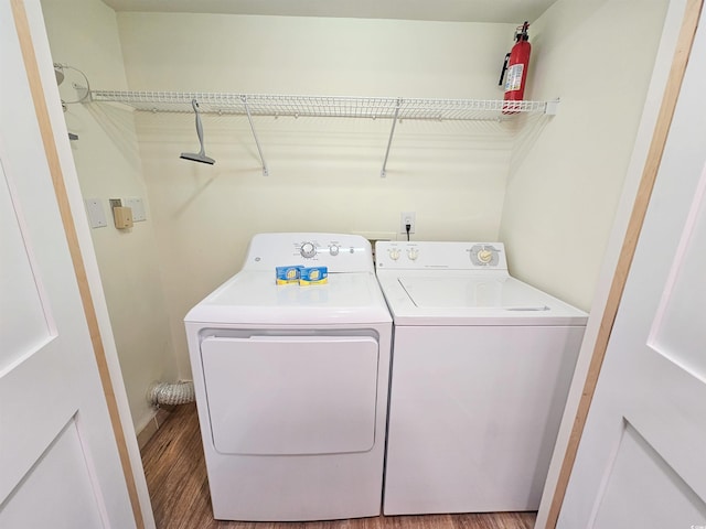 laundry room featuring washer and dryer, laundry area, and wood finished floors