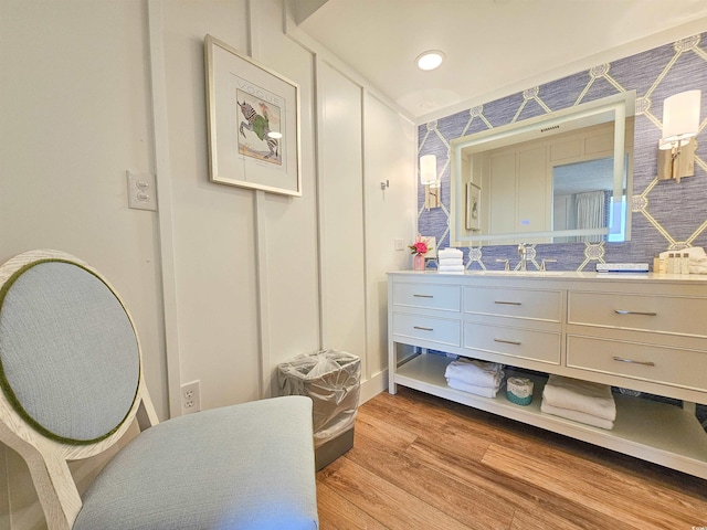 bathroom featuring wood finished floors, vanity, and recessed lighting