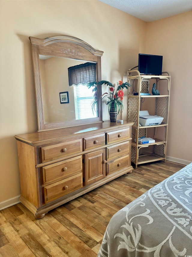 bedroom with hardwood / wood-style flooring