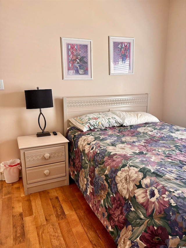 bedroom with hardwood / wood-style flooring