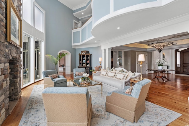9400 Lake Dr, Myrtle Beach, SC 29572 - living area with hardwood / wood-style floors, decorative columns, a towering ceiling, and ornamental molding