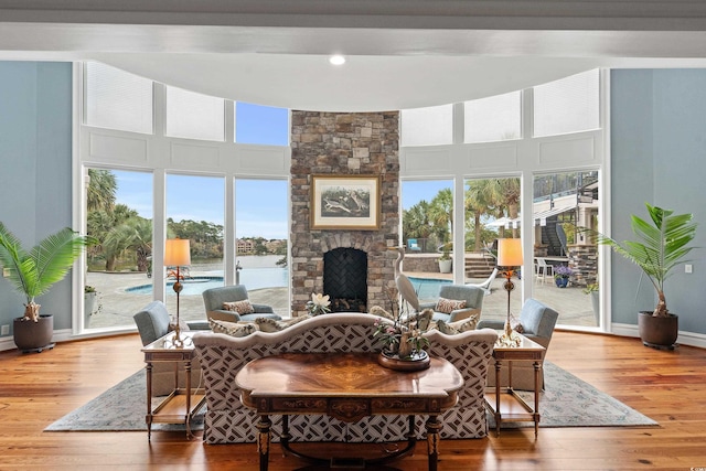 9400 Lake Dr, Myrtle Beach, SC 29572 - living room featuring hardwood / wood-style floors, baseboards, a fireplace, and a high ceiling