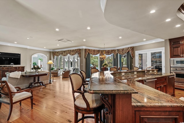 9400 Lake Dr, Myrtle Beach, SC 29572 - kitchen featuring visible vents, light wood-style flooring, a kitchen breakfast bar, and stainless steel appliances