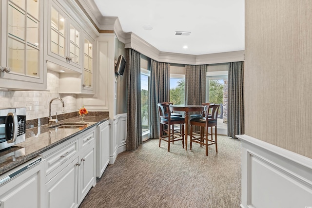 9400 Lake Dr, Myrtle Beach, SC 29572 - kitchen featuring stainless steel microwave, a sink, visible vents, and wainscoting