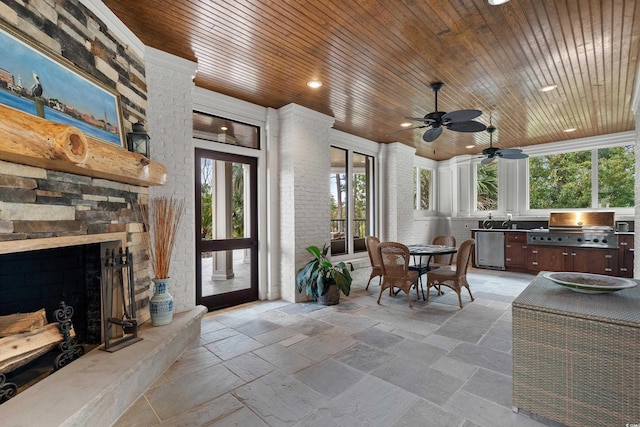 9400 Lake Dr, Myrtle Beach, SC 29572 - view of patio featuring a stone fireplace, outdoor dining space, area for grilling, and a ceiling fan