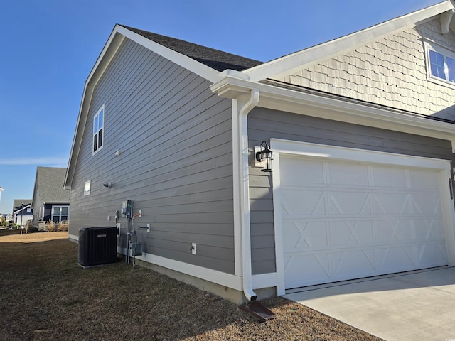 view of home's exterior featuring a garage and central AC unit