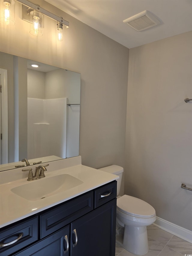 bathroom featuring vanity and toilet