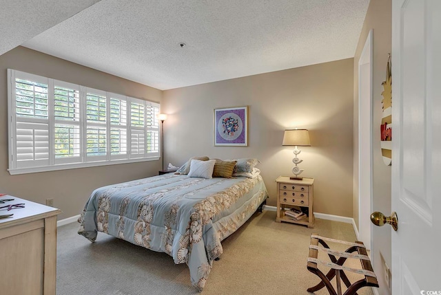 carpeted bedroom with a textured ceiling