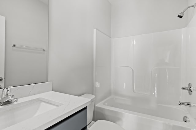 bathroom with vanity, toilet, and shower / washtub combination