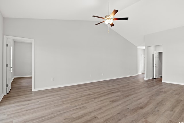 unfurnished living room featuring high vaulted ceiling, ceiling fan, baseboards, and wood finished floors