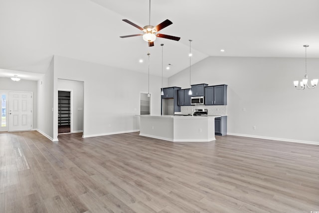 unfurnished living room with high vaulted ceiling, baseboards, ceiling fan with notable chandelier, and light wood-type flooring