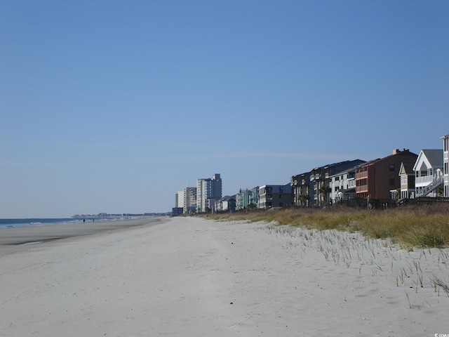 exterior space featuring a beach view and a water view