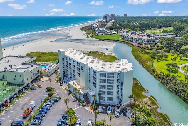 drone / aerial view with a beach view and a water view