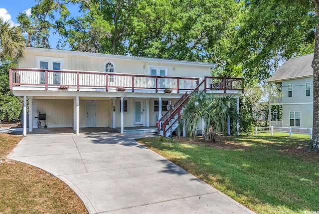 view of front of property with a front lawn and a carport