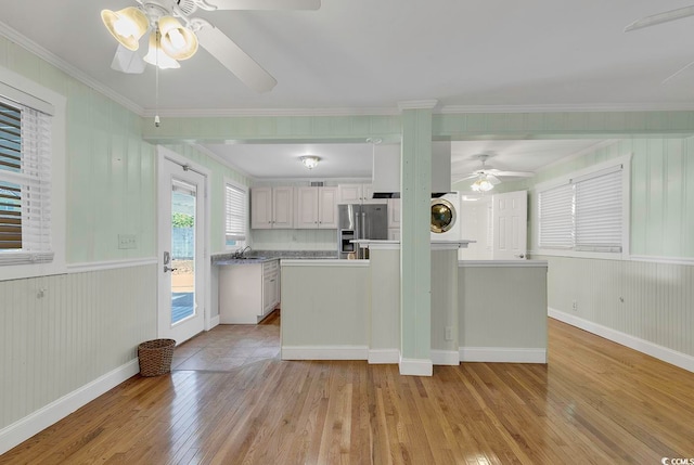 kitchen with ceiling fan, sink, white cabinetry, washer / clothes dryer, and stainless steel refrigerator with ice dispenser