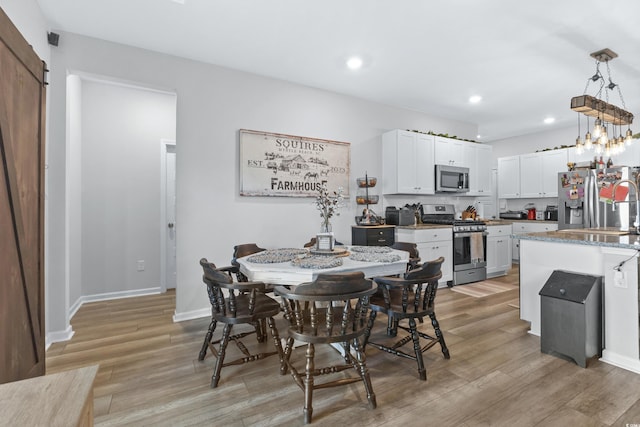 dining room featuring light wood-type flooring and sink