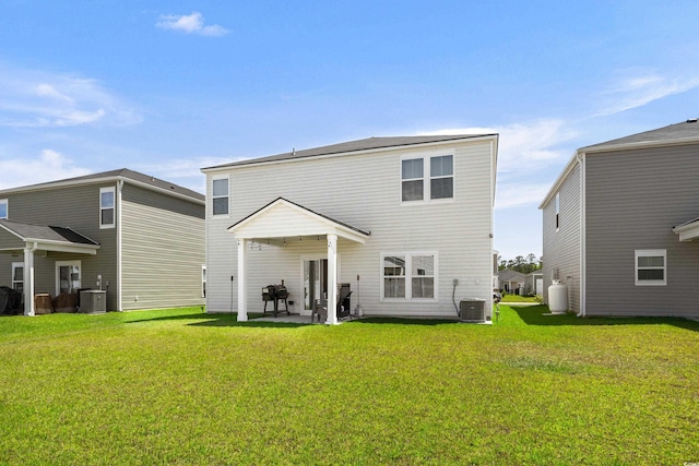 back of property featuring a lawn, a patio, and central AC