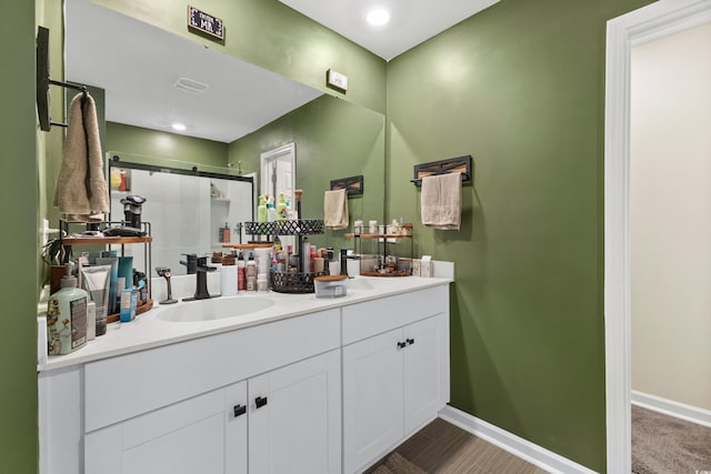 bathroom featuring vanity and an enclosed shower