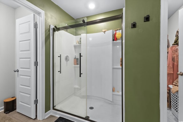 bathroom with a shower with door