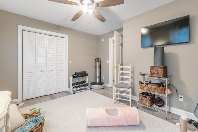 interior space with ceiling fan, baseboards, and wood finished floors