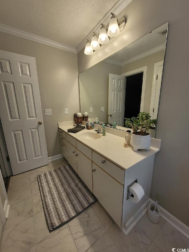 bathroom featuring ornamental molding, marble finish floor, vanity, and a textured ceiling