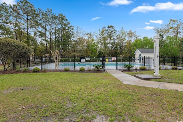 surrounding community featuring a swimming pool, a lawn, and fence