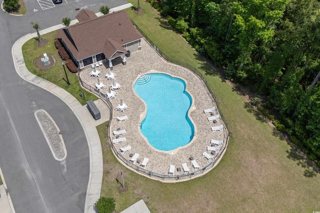 view of pool featuring a lawn