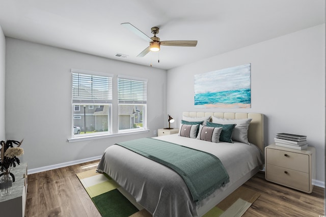 bedroom with dark wood-type flooring and ceiling fan