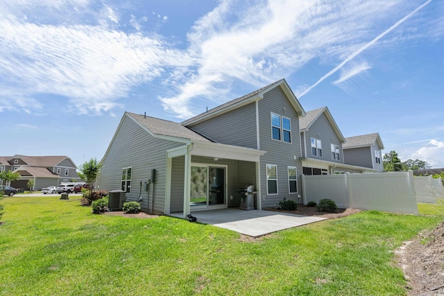 back of property featuring cooling unit, a yard, and a patio