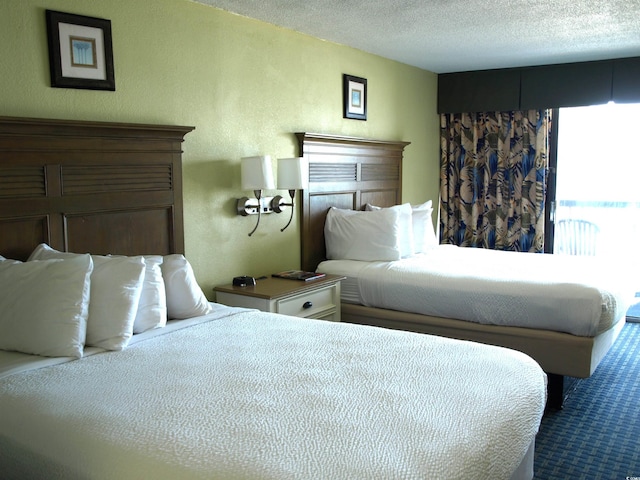 bedroom featuring carpet and a textured ceiling