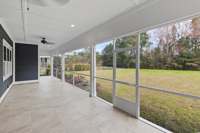 unfurnished sunroom with ceiling fan