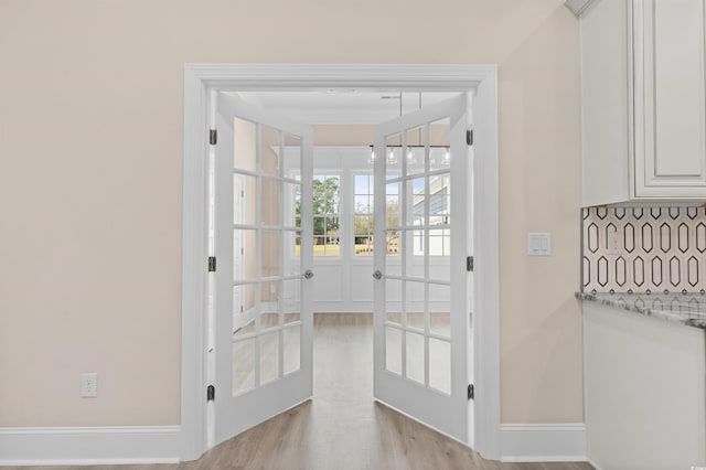 entryway with light hardwood / wood-style floors and french doors