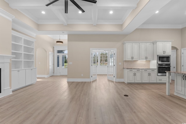 kitchen with white cabinets, stainless steel appliances, light hardwood / wood-style floors, backsplash, and beam ceiling