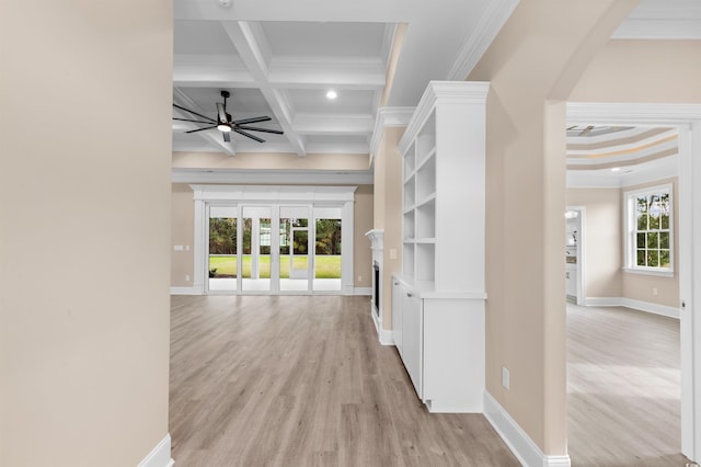 hallway with coffered ceiling, beamed ceiling, a healthy amount of sunlight, and ornamental molding