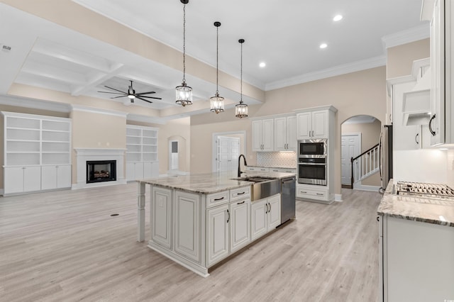 kitchen featuring pendant lighting, white cabinets, stainless steel appliances, a kitchen island with sink, and coffered ceiling