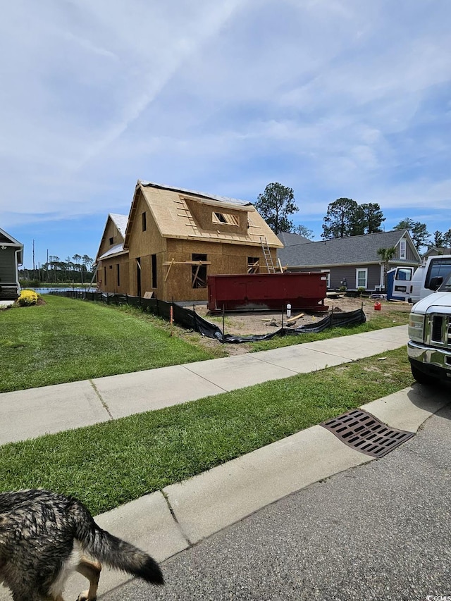 view of side of property with a yard