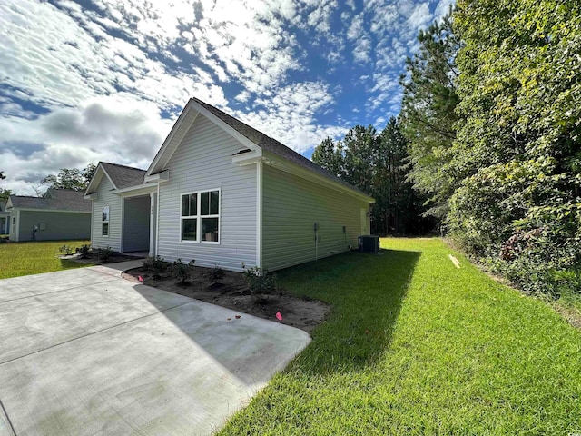 view of home's exterior with central air condition unit and a lawn