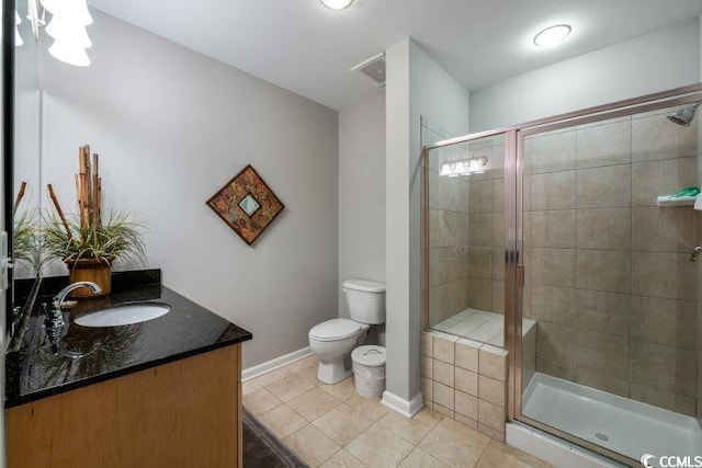 bathroom with tile flooring, a shower with door, vanity, and toilet