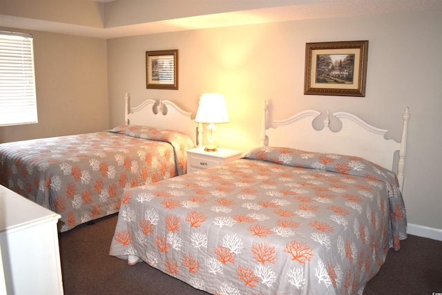 bedroom with dark colored carpet