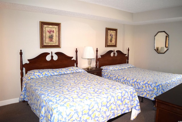 bedroom with carpet flooring and a textured ceiling