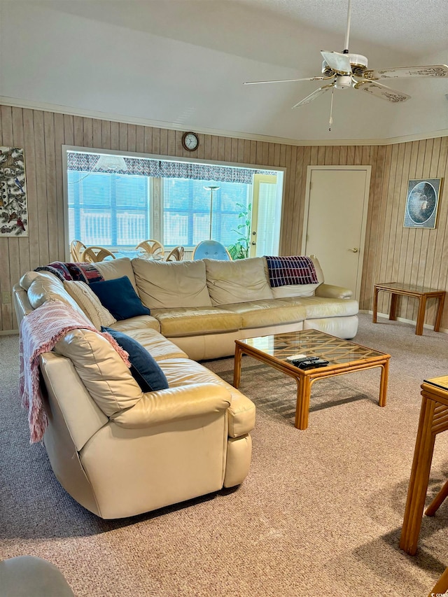 carpeted living room with wood walls and ceiling fan