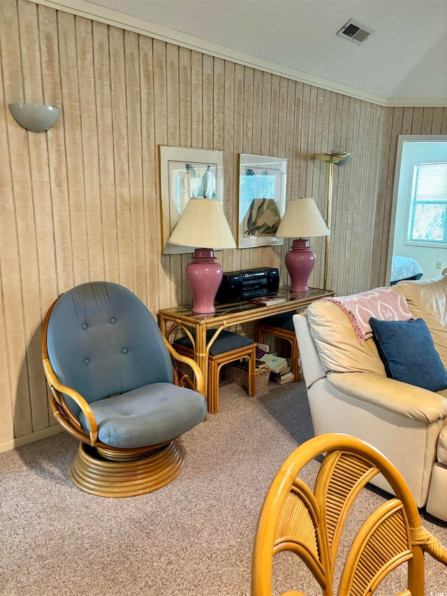 interior space with ornamental molding and carpet flooring