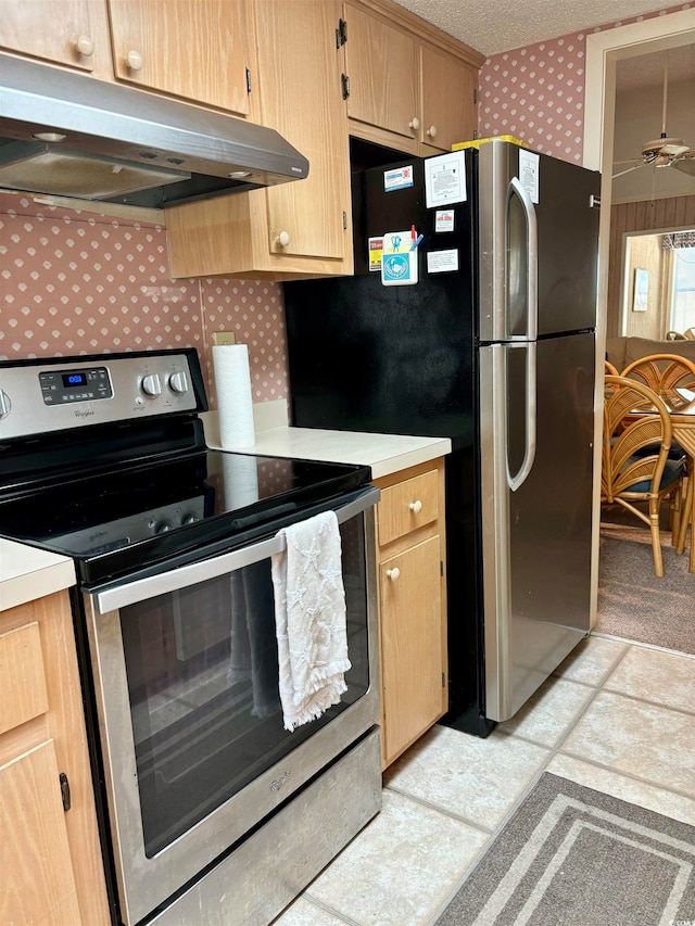 kitchen with light brown cabinetry, ceiling fan, light tile floors, and electric stove