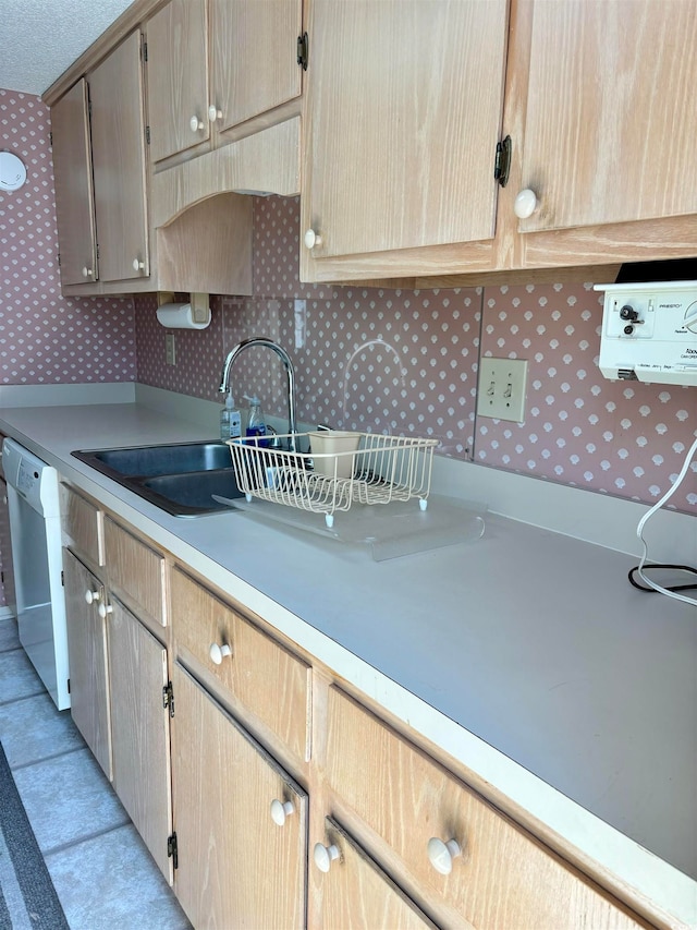 kitchen featuring dishwasher and light tile floors