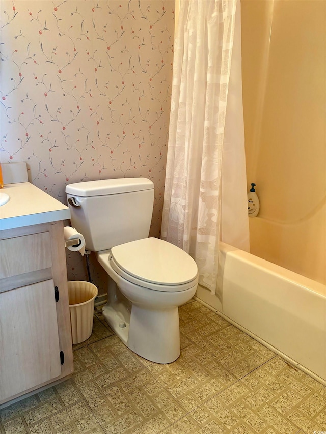 full bathroom with tile flooring, shower / tub combo, vanity, and toilet