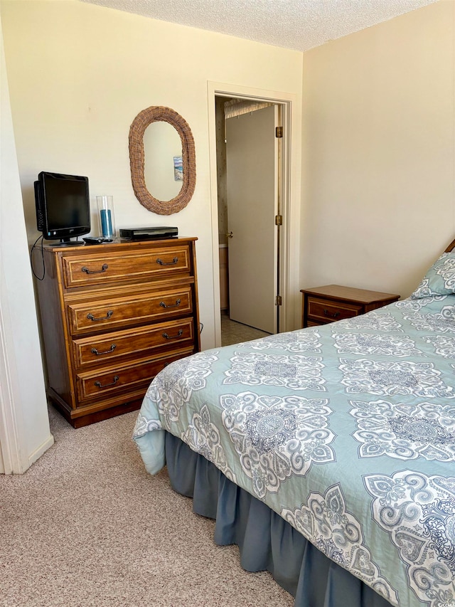 carpeted bedroom with a textured ceiling